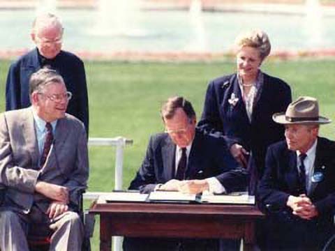 President George H. W. Bush signs Americans with Disablilites Act