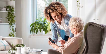 Caregiver and Older Adult with Cellphone