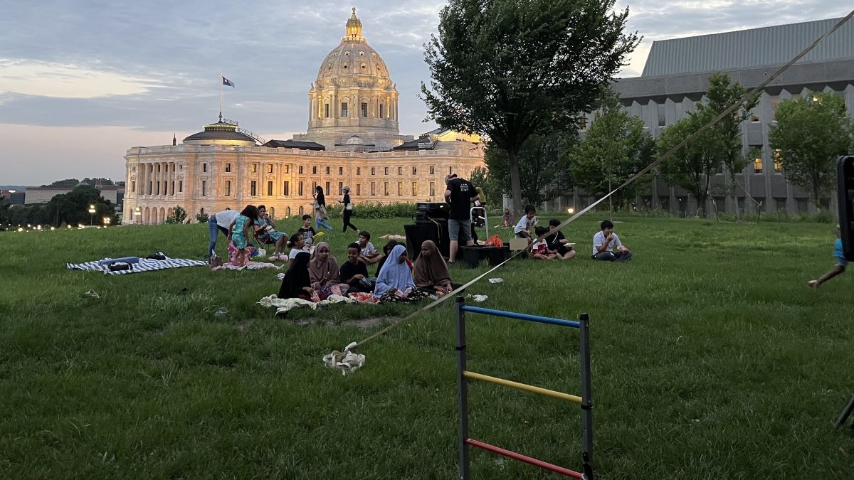 A movie is being shown in Cass Gilbert Memorial Park with the Minnesota State Capitol Building in the background