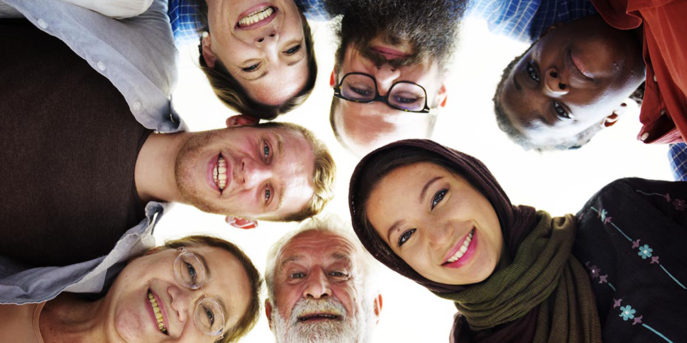 a diverse group of adults staring down at a camera