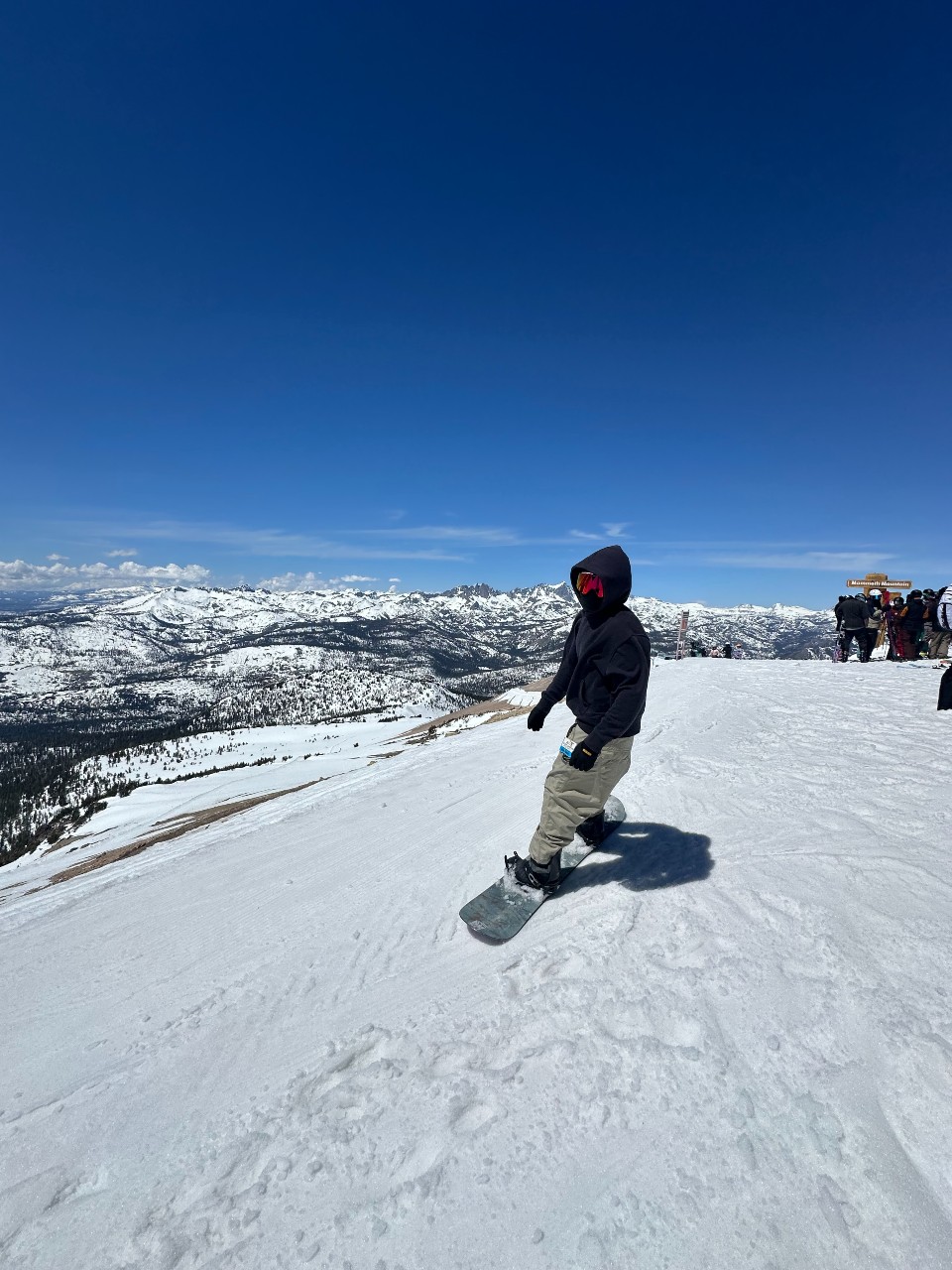 Action shot of Kole on his snowboard, gliding downhill. 