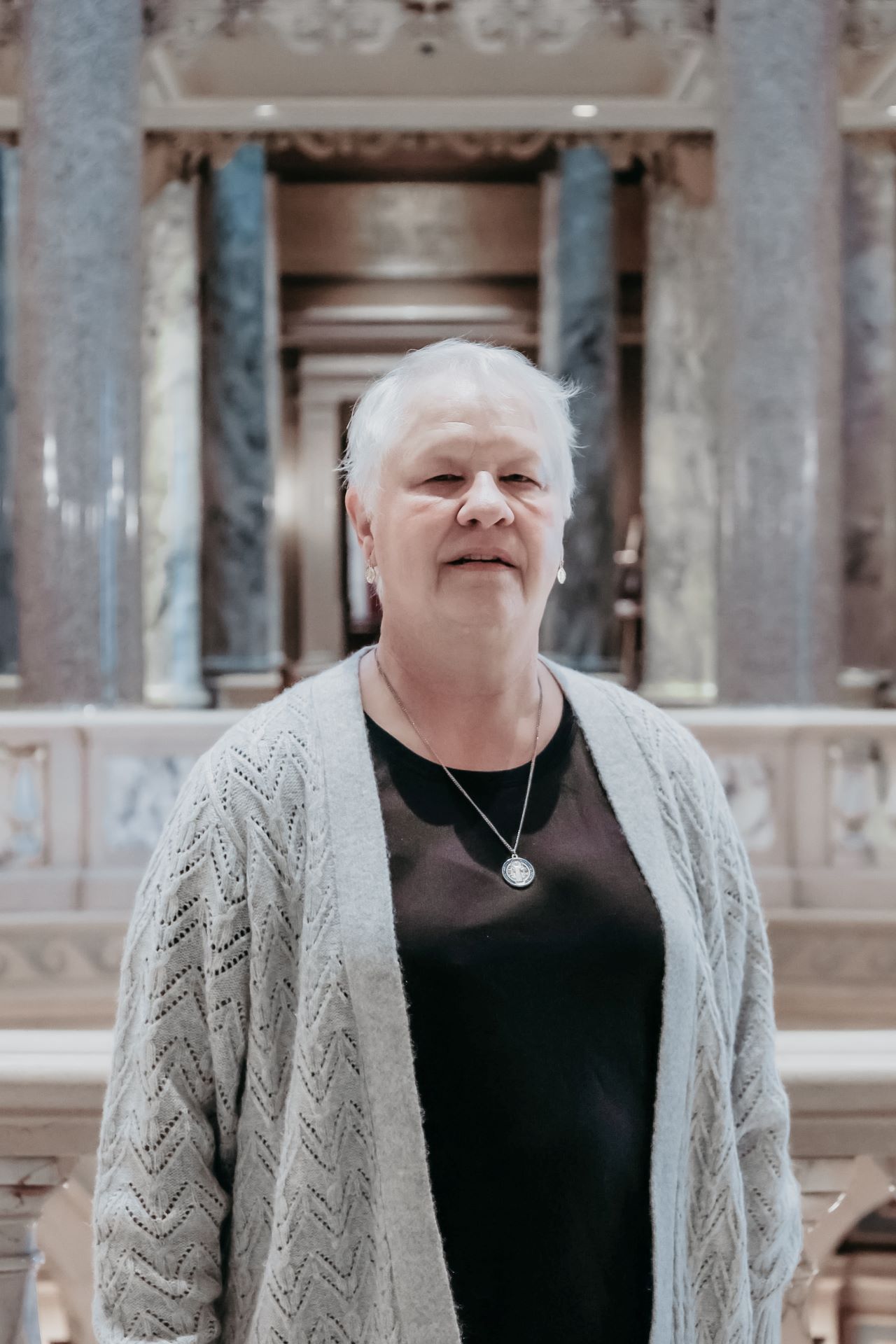 Person standing within the Capitol Building, near the Rotunda