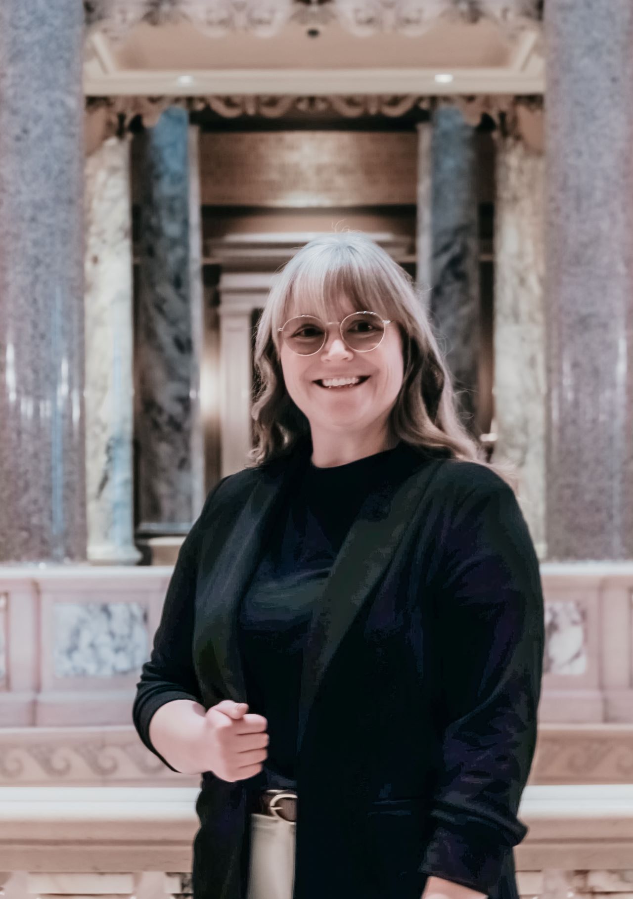 Person standing within the Capitol Building, near the Rotunda