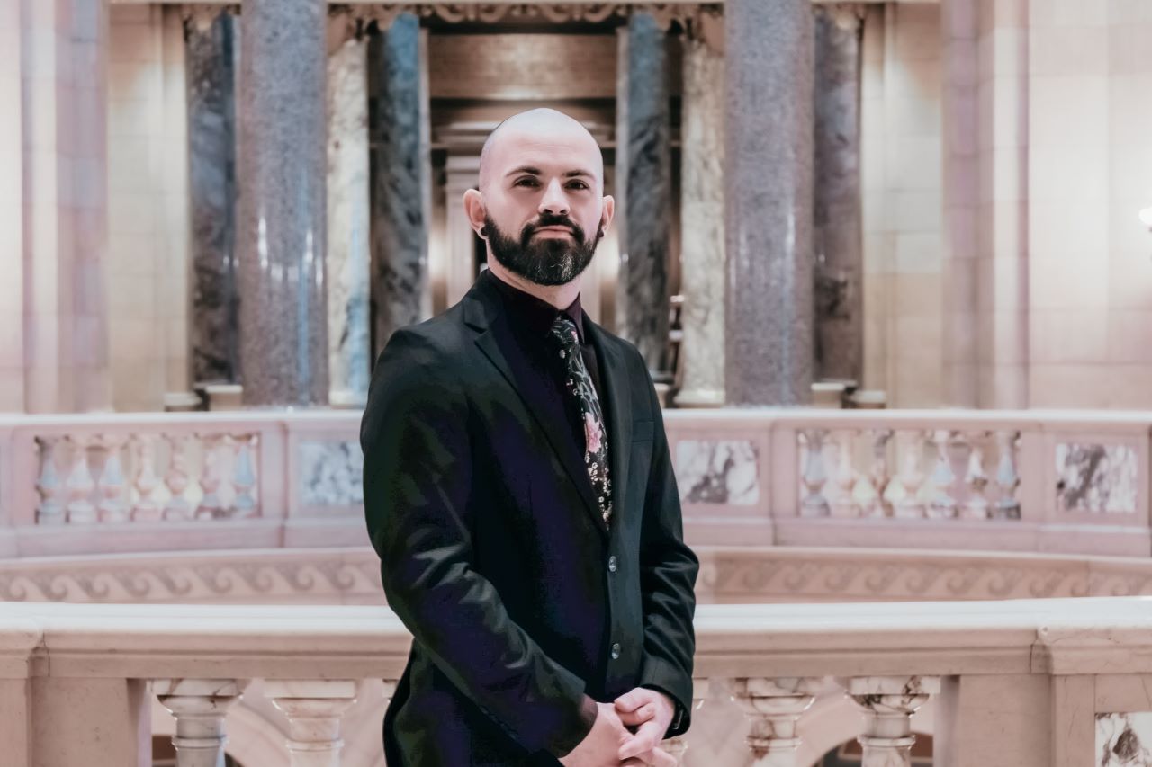 Person standing within the Capitol, near the interior rotunda
