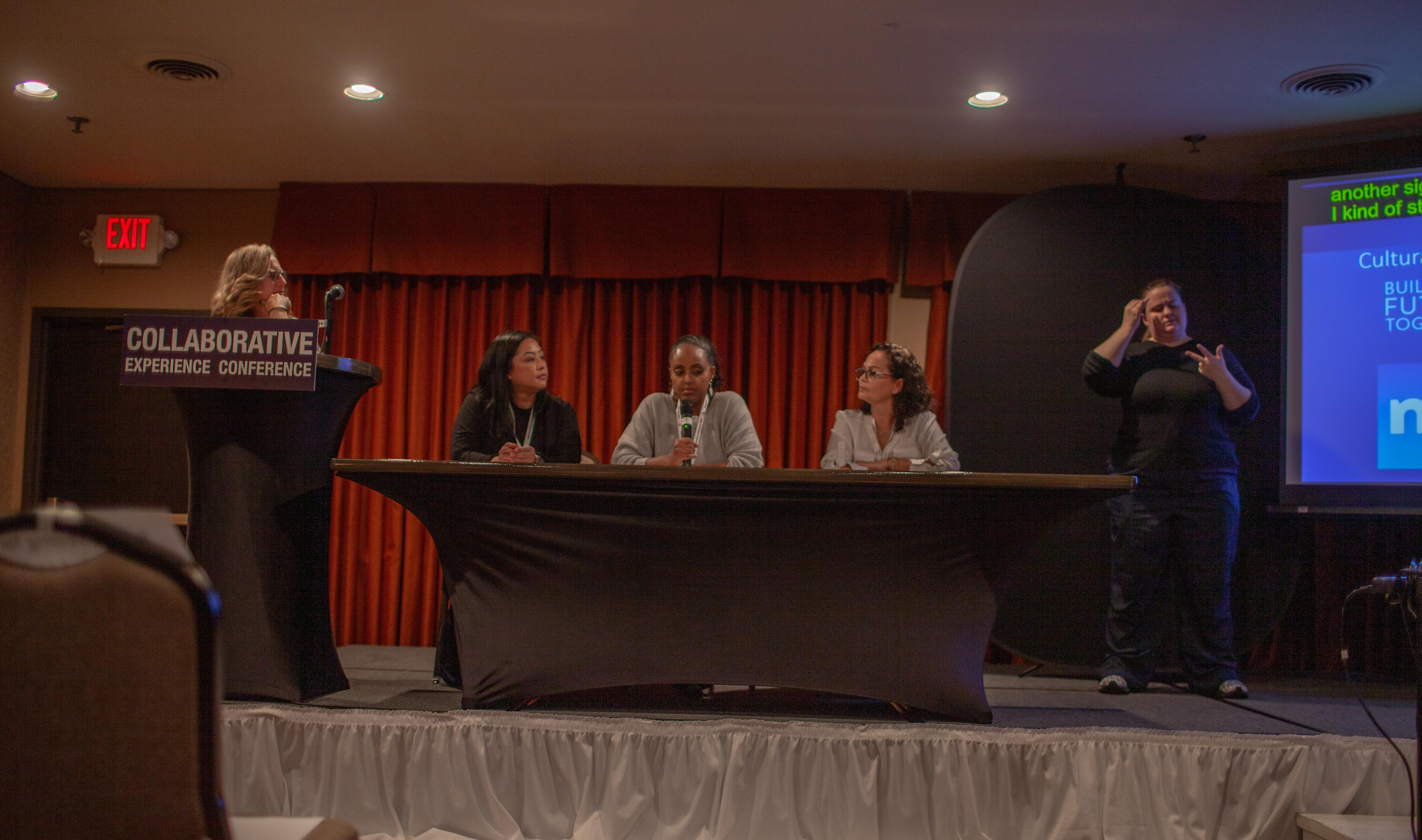 Parent workshop with interpreters, cart, and PPT onstage from the 2024 Collaborative Experience Conference