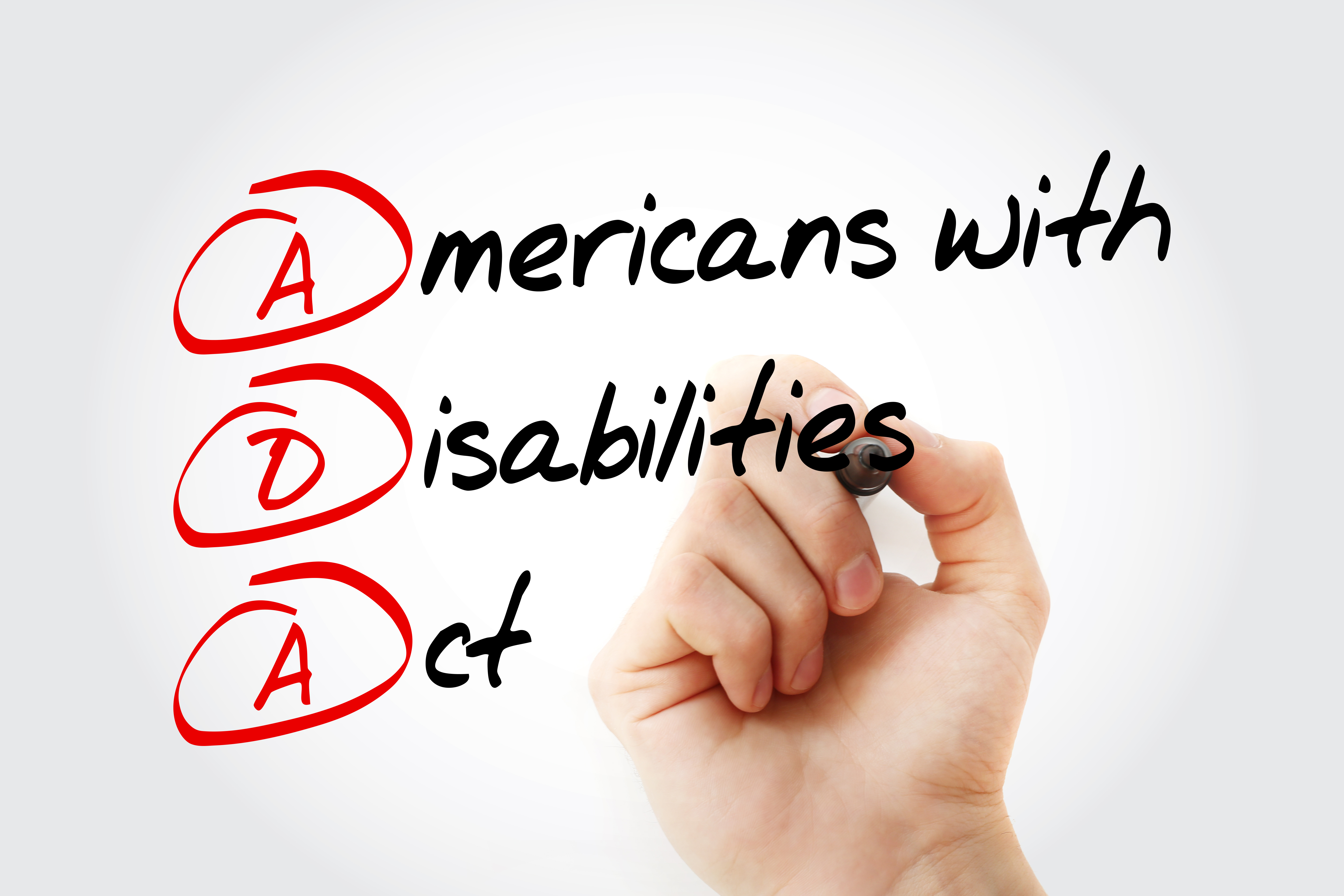 Americans with Disabilities Act written on glass. The letters ADA are circled.