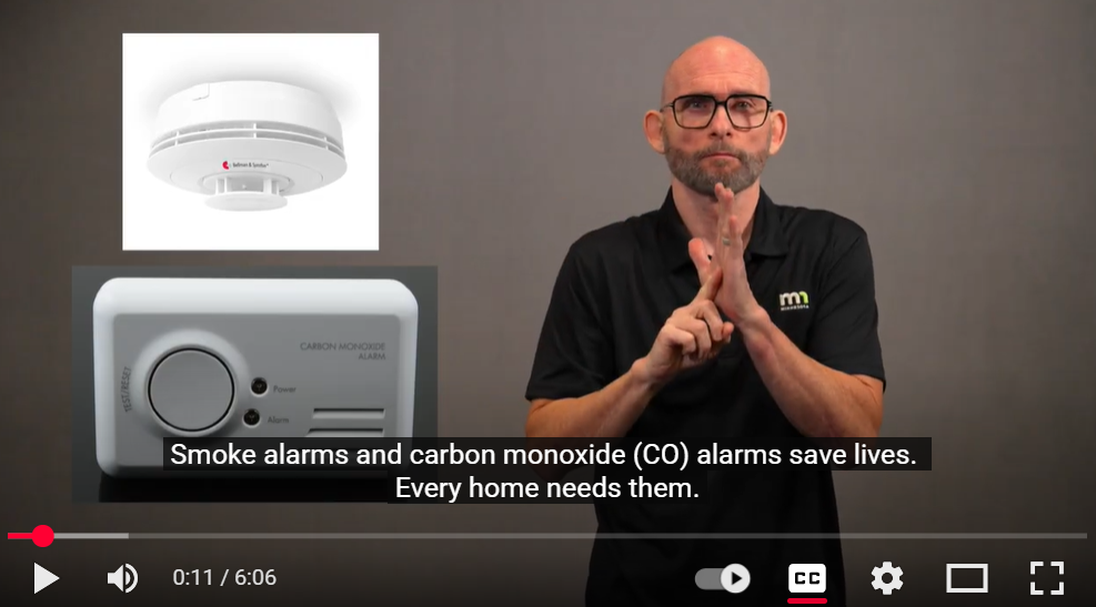 Alex signs ALARM next to pictures of smoke detectors and carbon monoxide alarms. Captions read: Smoke and carbon monoxide (CO) alarms save lives. Every home needs them.