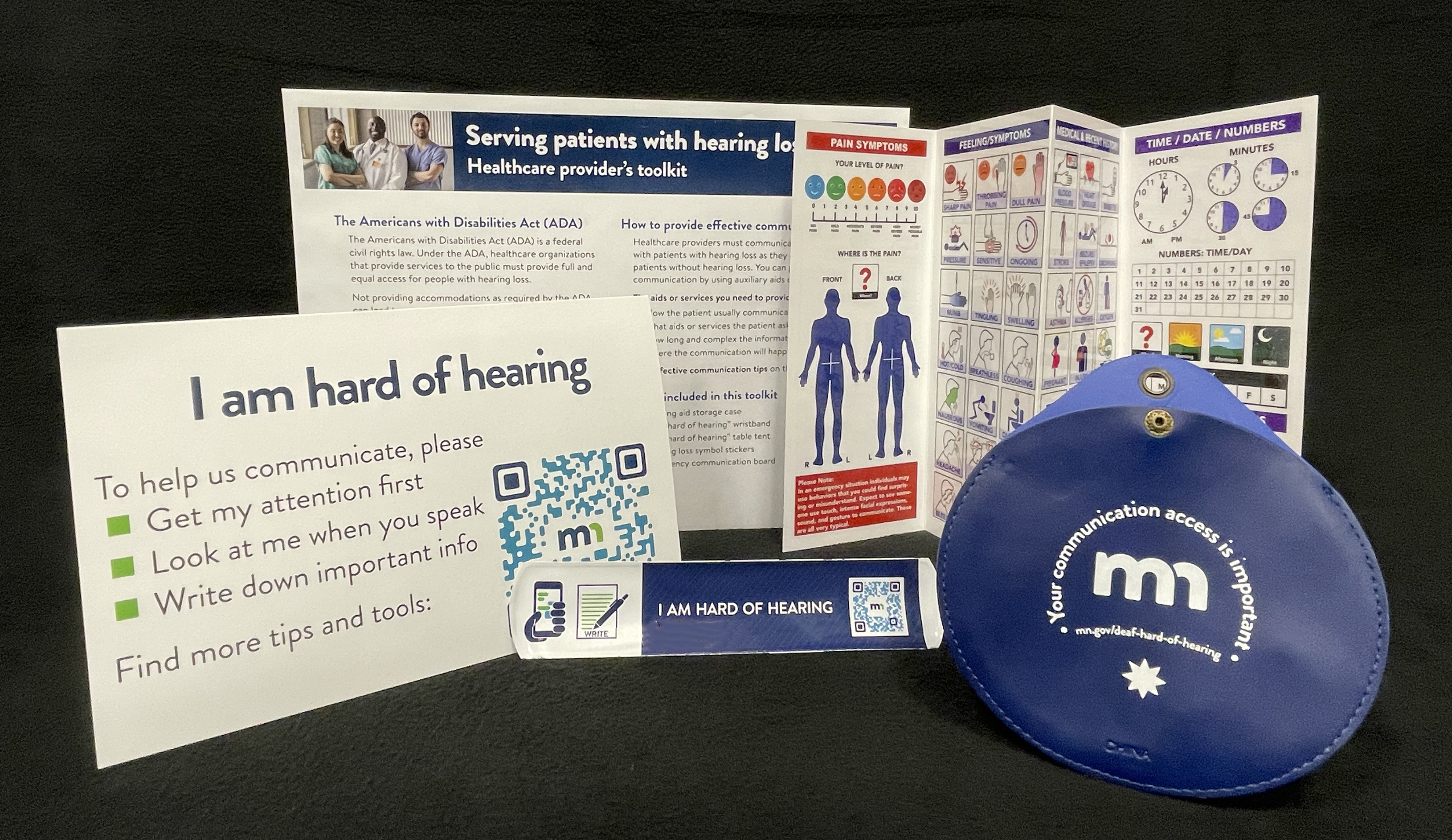 Hospital toolkit, containing communication tips, an Emergency communication board, table tent, wristband, and hearing aid storage case.