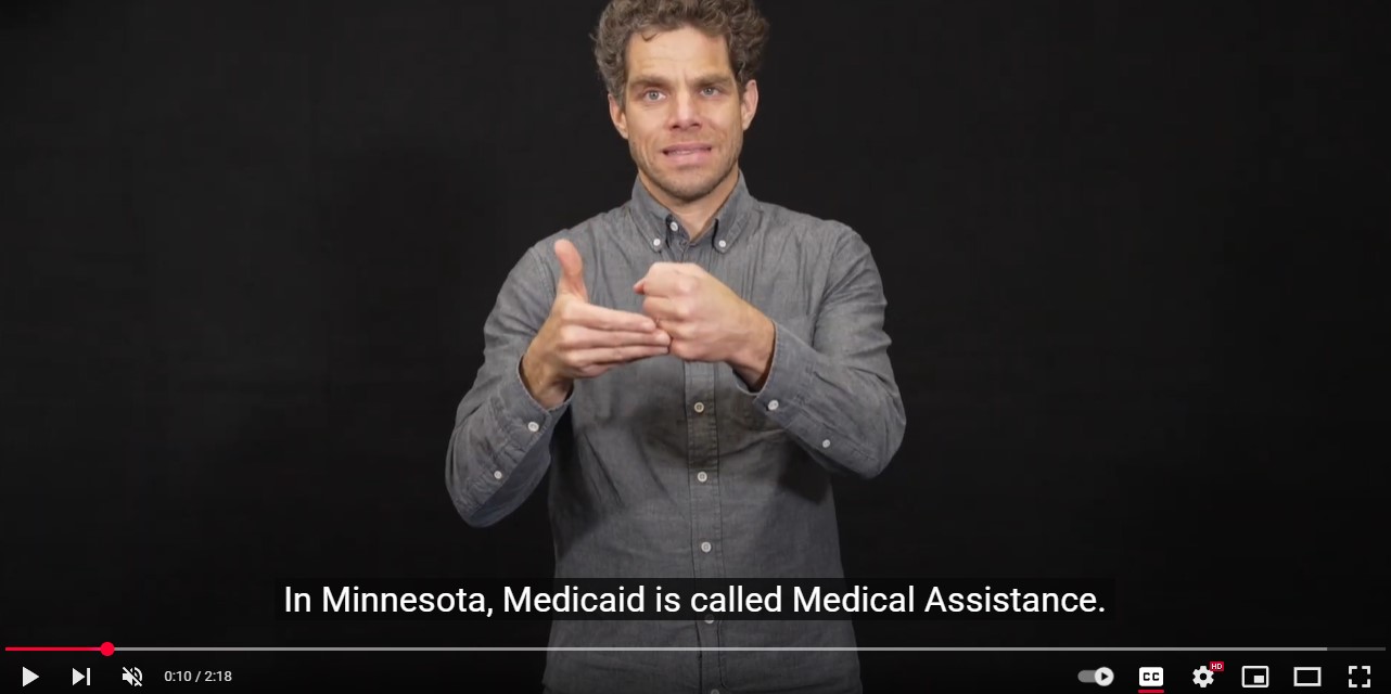 Dan Millikin signing assistance. Captions read: In Minnesota, Medicaid is called Medical Assistance.