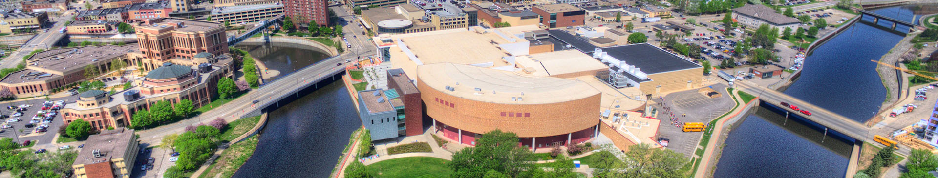 Banner image of a building in the bend of a river
