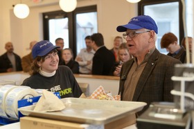 Governor Walz stands behind the Marty's Deli deli counter alongside an employee. Governor Walz stands behind the Marty's Deli deli counter alongside an employee.