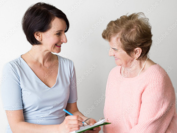 Elderly woman answering questions with case worker