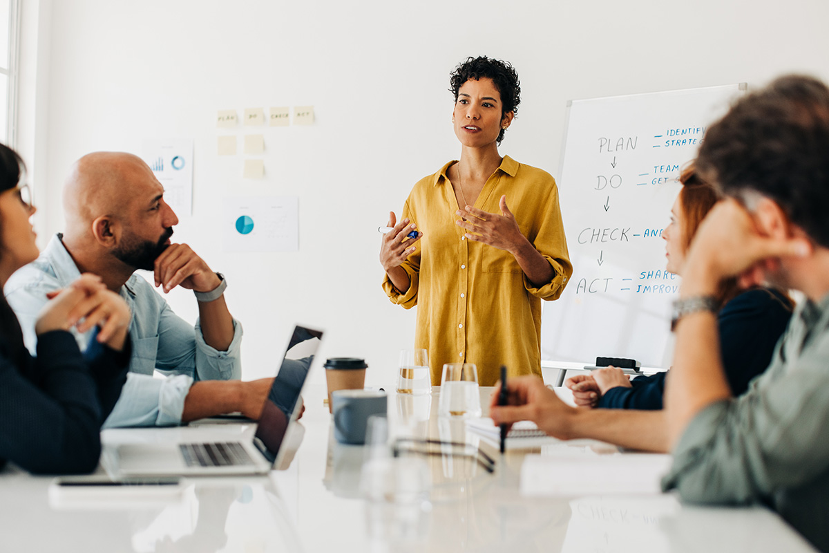 African American business woman giving a speech in a boardroom meeting