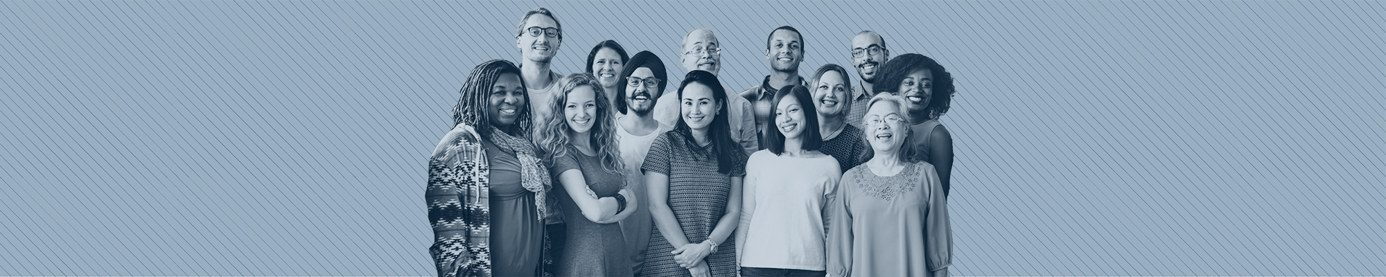 A diverse group of workers smiling at the camera