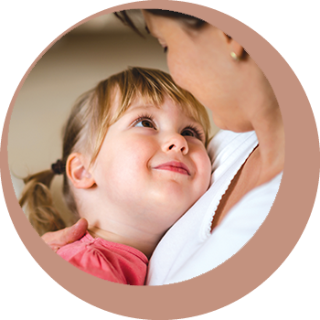 girl smiling up at mother