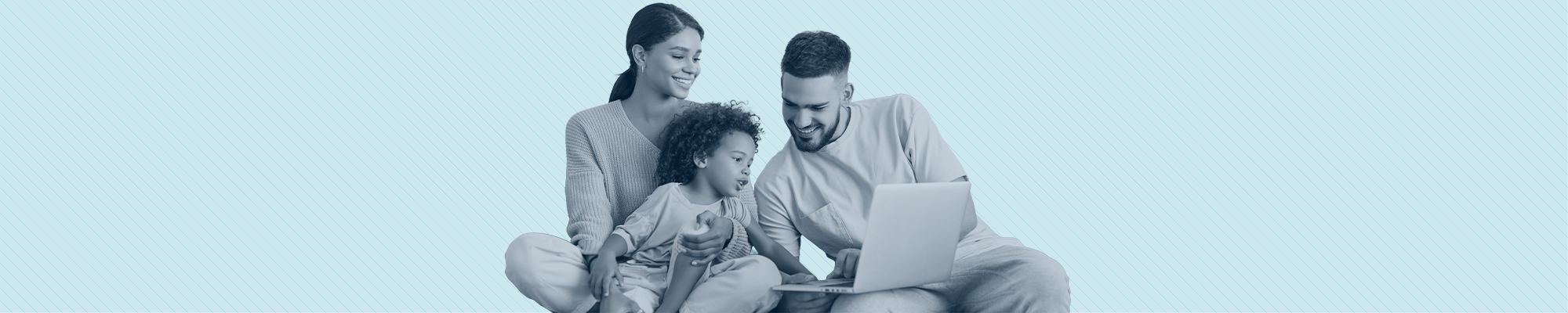 A young family smiling while filling out an application together