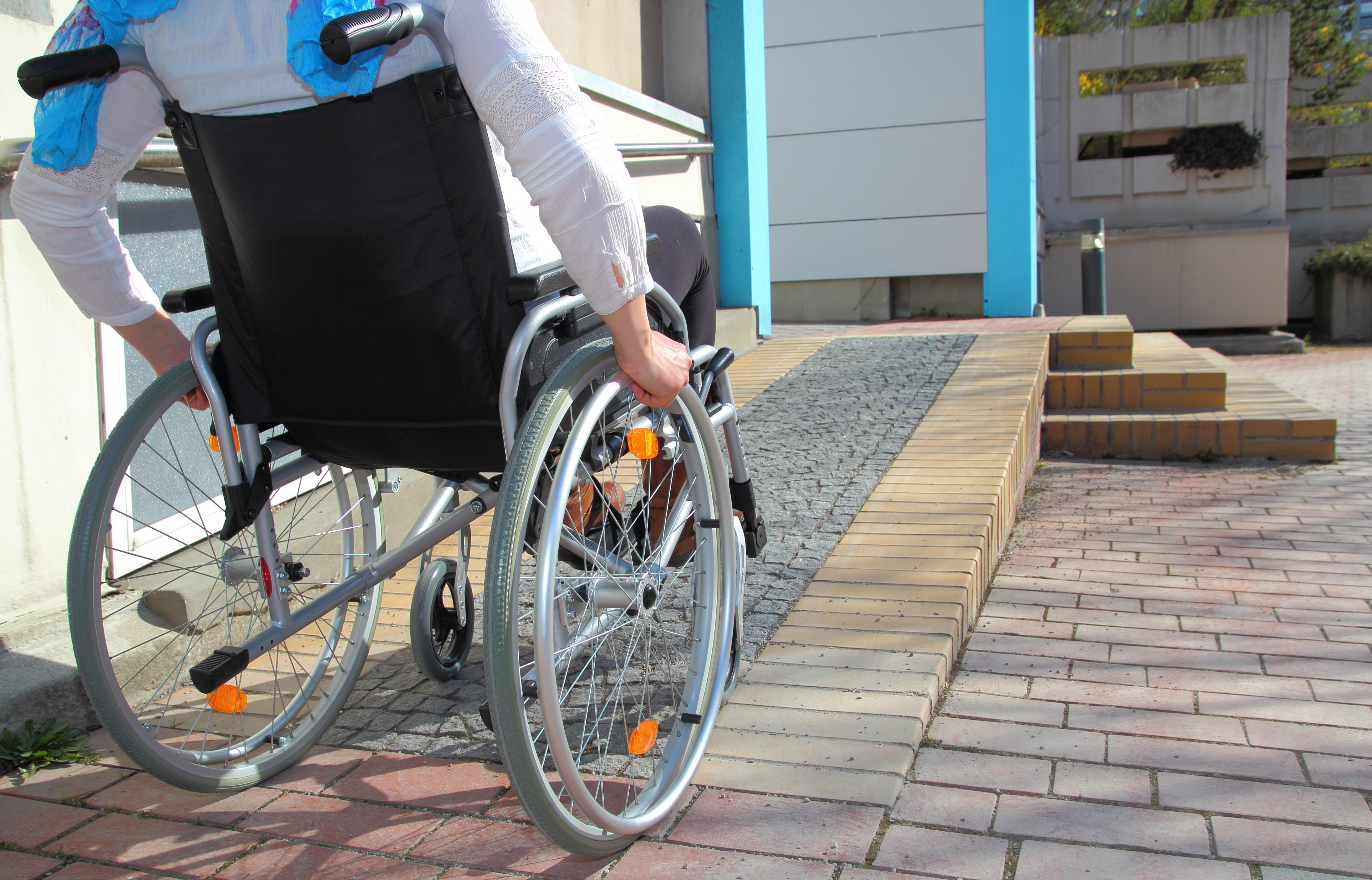 Person in wheelchair going up ramp