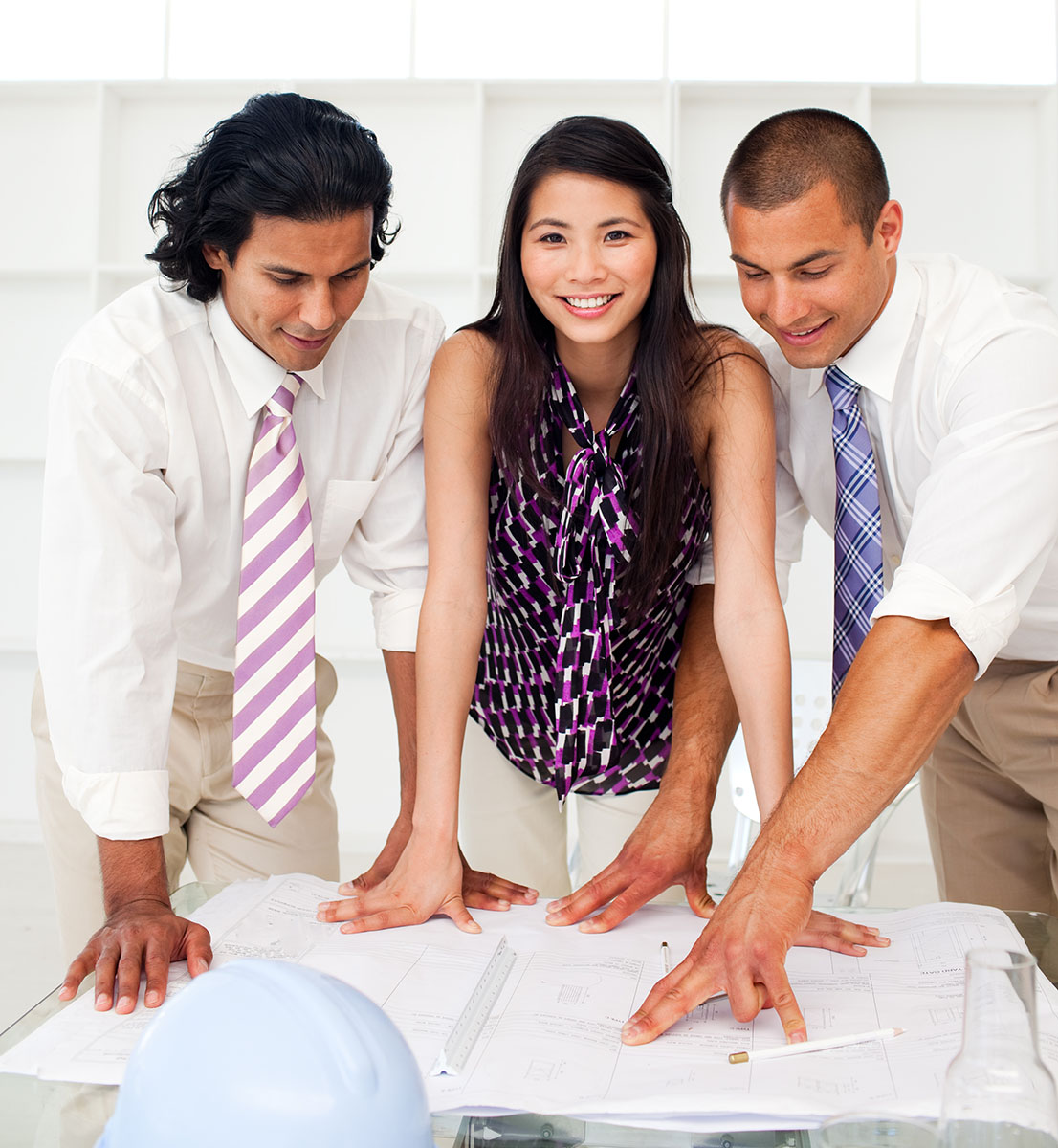 Woman and two men looking at engineering plans