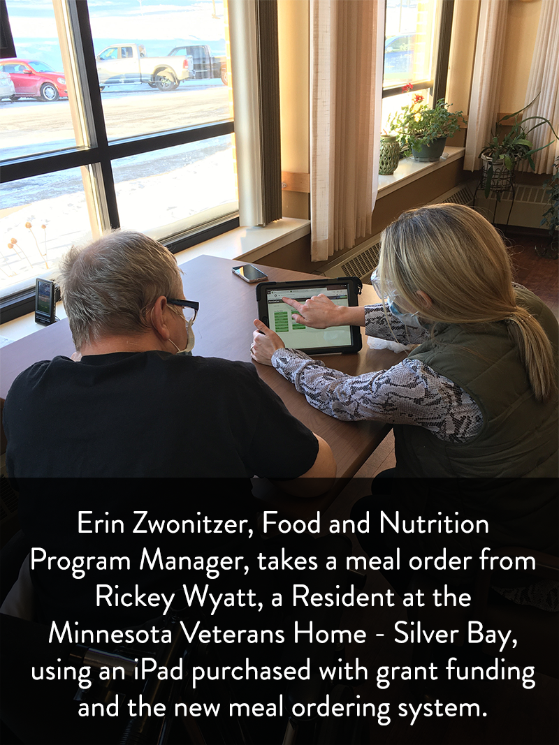 Erin Zwonitzer, Food and Nutrition Program Manager, takes a meal order from Rickey Wyatt, a Resident at the Minnesota Veterans Home - Silver Bay, using an iPad purchased with grant funding and the new meal ordering system.