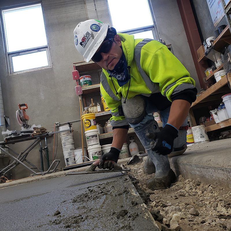 An apprentice learns the skills of their trade in a school setting and on the job.