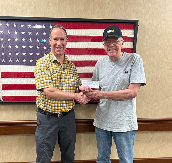 Dennis Johnson, Chapter Treasurer of the Fergus Falls Disabled American Veterans (DAV) Chapter 25 presents a check to Gary Harris of the Fergus Falls Veterans Homes to fulfill a pledge of more than $31,000 to pay for cable and Wi-Fi for Residents.