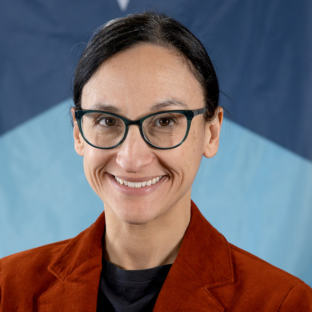 Leah Corey portrait. A Minnesota State Flag is behind Leah.