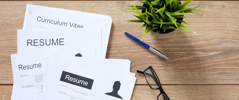 Stack of resumes on a desk.