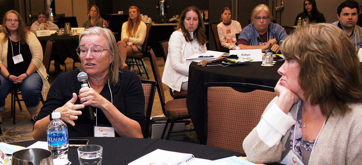 A group seated around a table participating in week 2 of class 40 Partners in Policymaking<