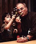 Man and boy blowing bubbles.
