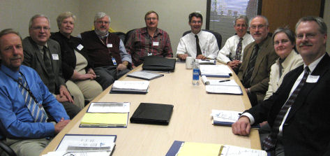 Team of GIS professionals sits around a conference table