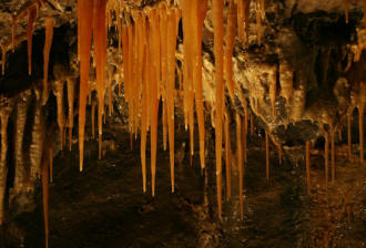 Orange stalactites formed by dripping water