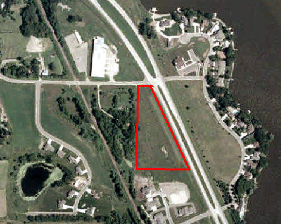Aerial photograph shows red outline around empty parcel