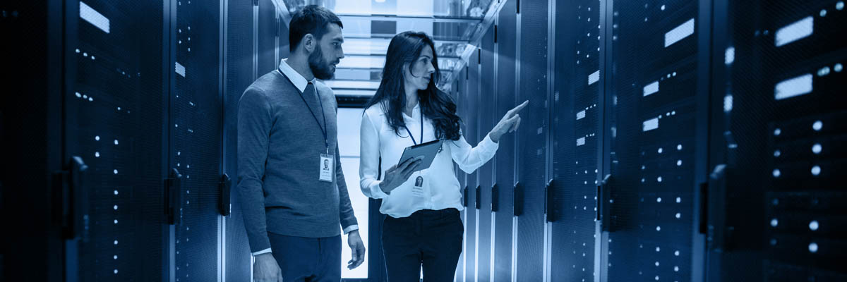 A man and woman working on a server.