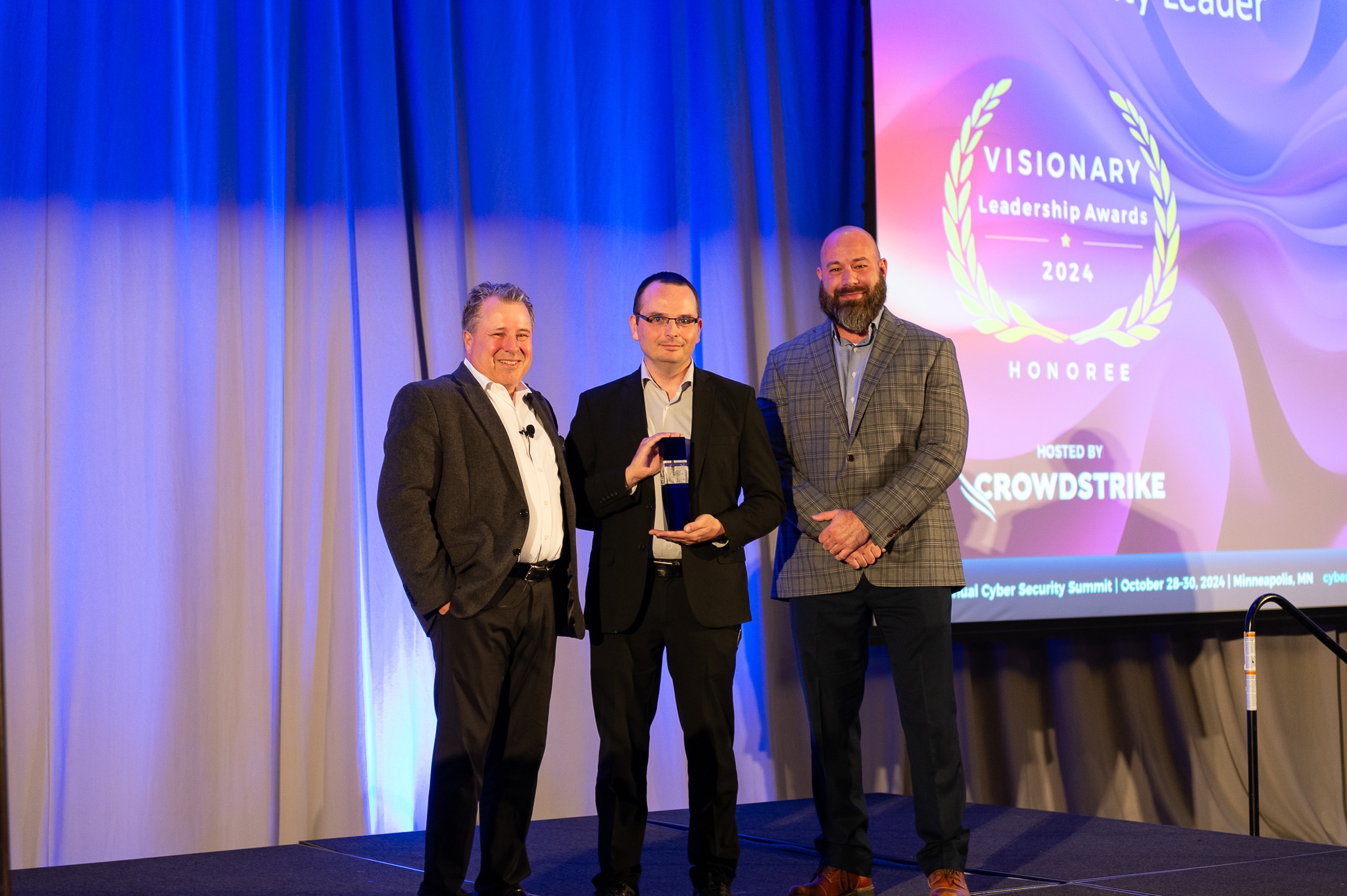 Chris Luhman receives an award at the Cyber Security Summit 2024