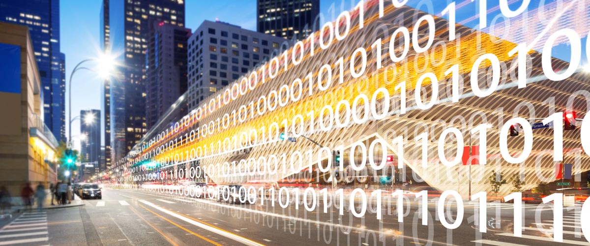 A city street at night lined with binary code.
