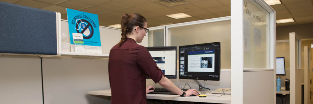 Accessibility intern Molly working at her desk.