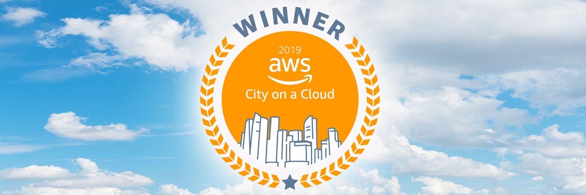A bright cloudy sky with a seal that reads: Winner 2019 AWS City on a Cloud.