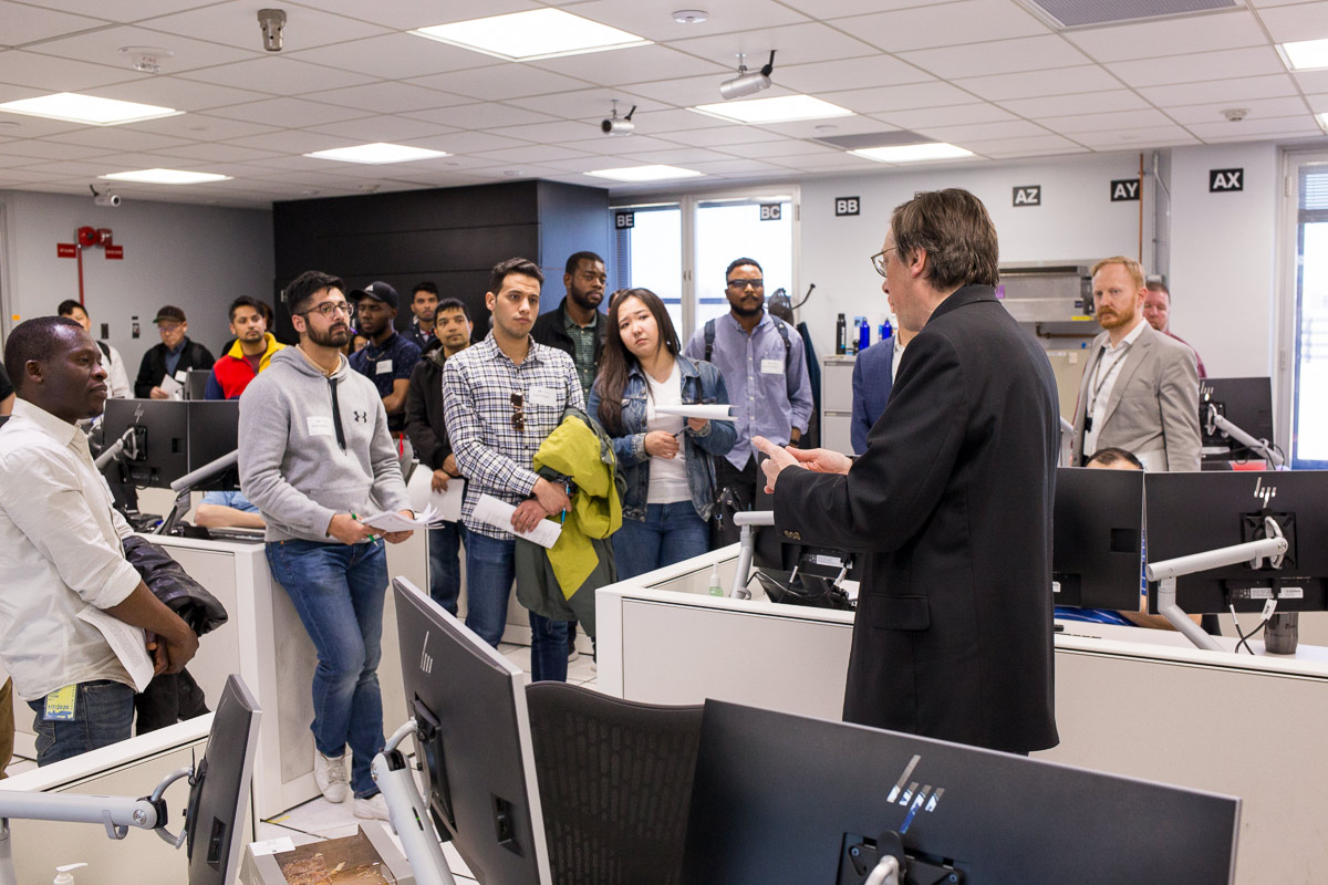 The MNIT Security Team talking with a group of cybersecurity students.