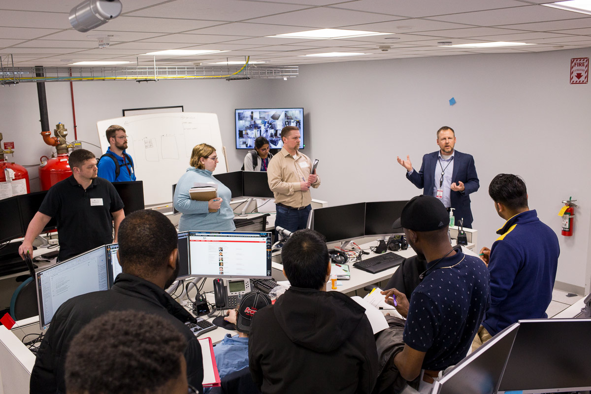 cybersecurity-student-tour-002 The MNIT Security Team talking with a group of cybersecurity students.