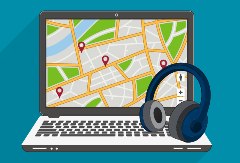 A laptop displaying a map with location pins is shown alongside a pair of headphones resting on the keyboard