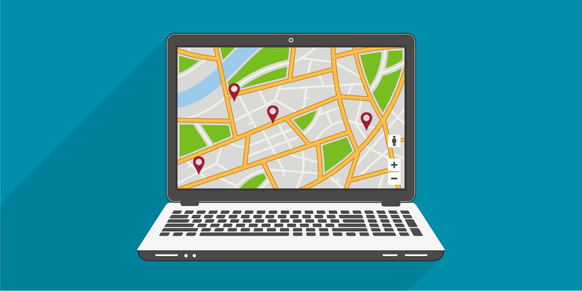 Laptop displaying interactive street map with pins marking various points.
