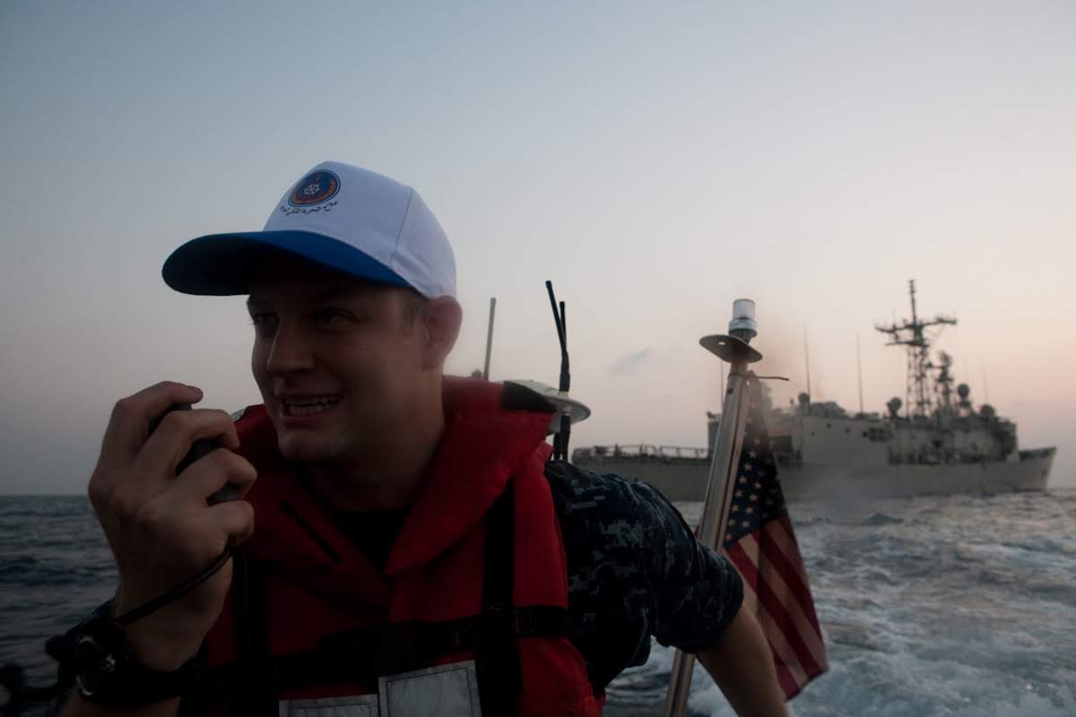 Jeffrey Duvio on a Navy ship speaking into a radio.