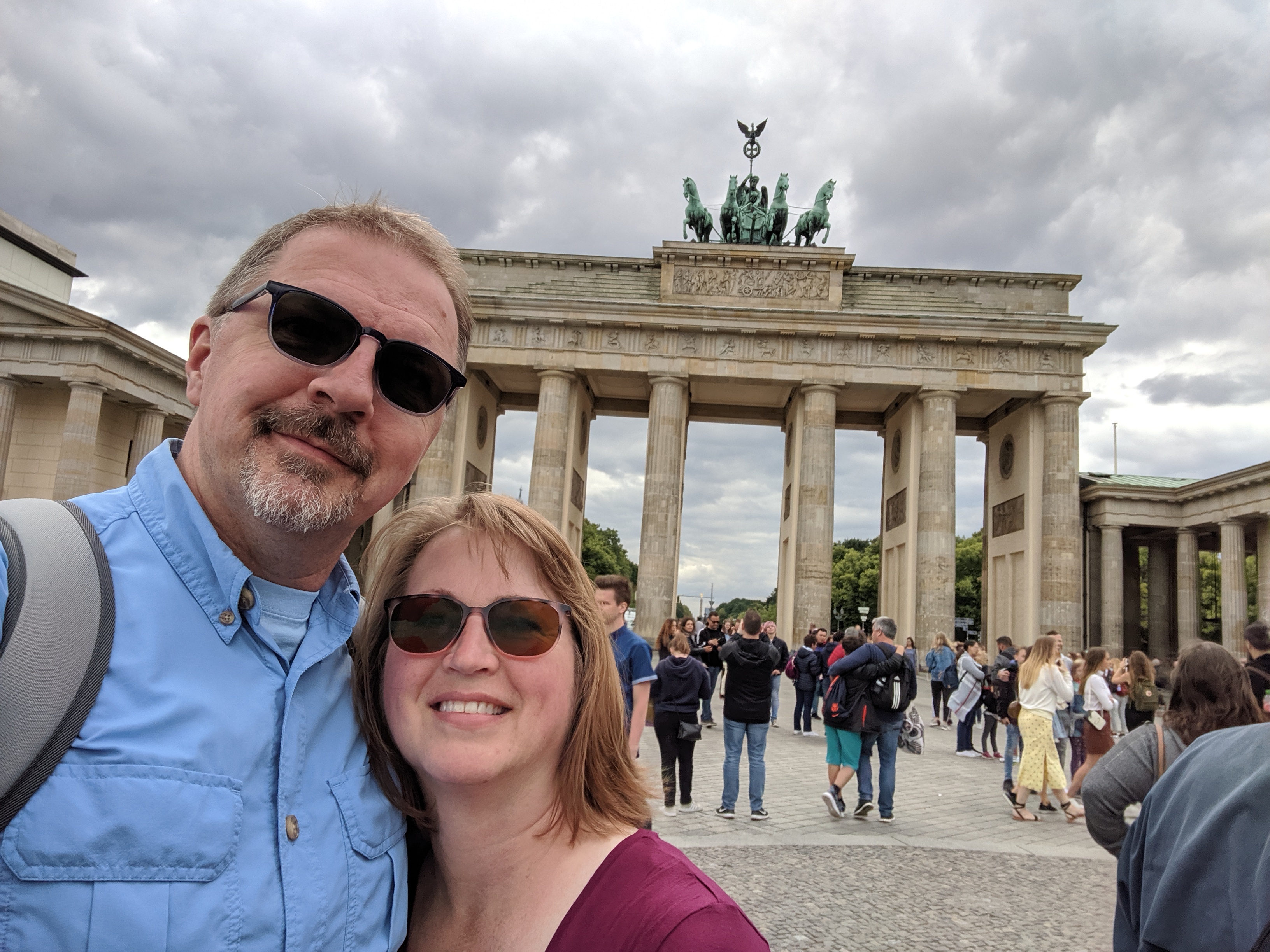 Dan Kuntz and his wife smiling in front of the Brandenburg Gate.