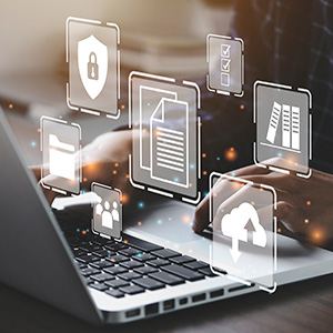 A person using a laptop with icons of documents, files, and a cloud computing icon floating in front of it