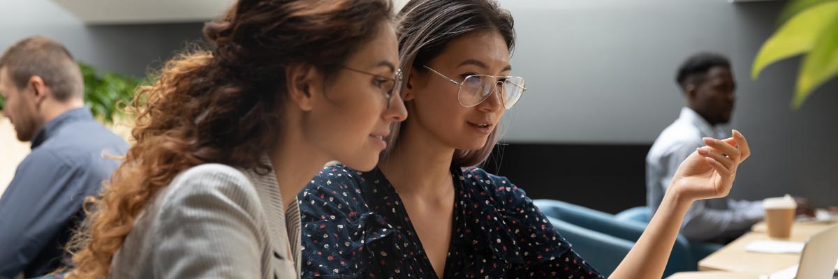 Two women looking at a laptop computer.