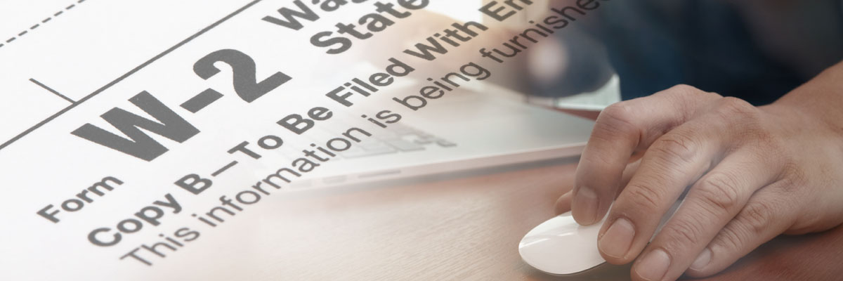 A person in front of a computer with an overlay of a W2 tax statement.