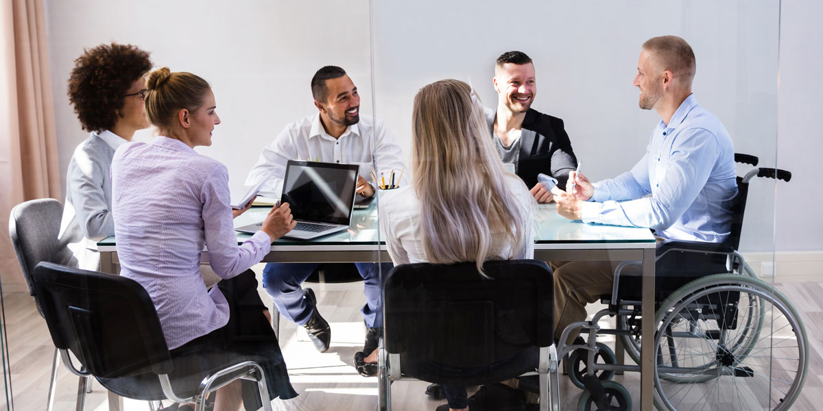 People sitting around a table working.