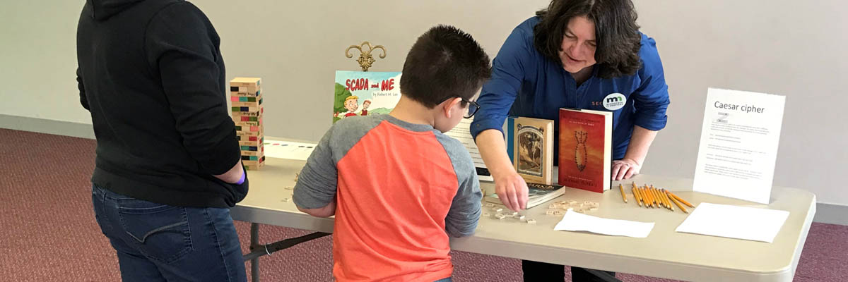 MNIT's Nancy Skuta demonstrating cybersecurity game activities at the Works Museum.
