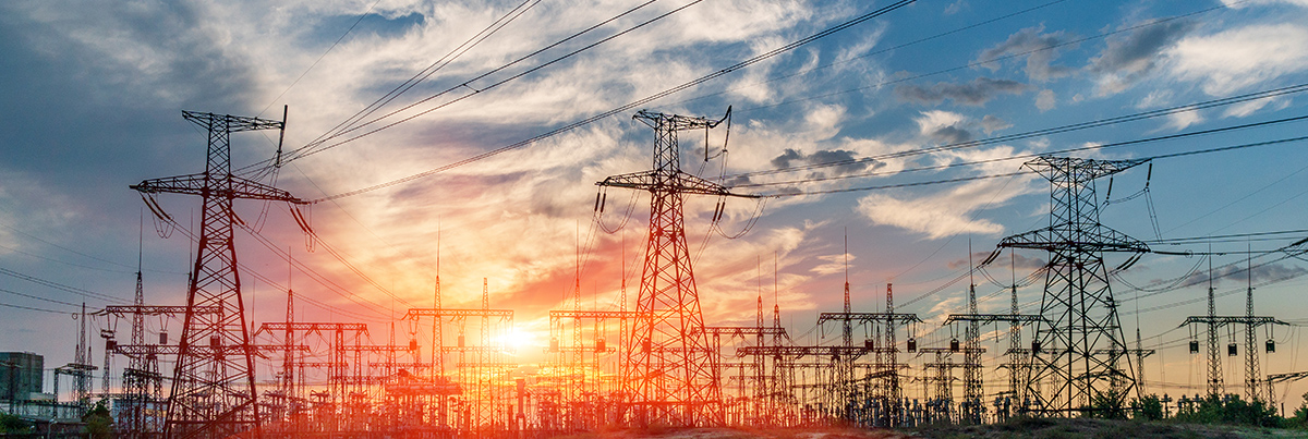 Transmission towers at sunset