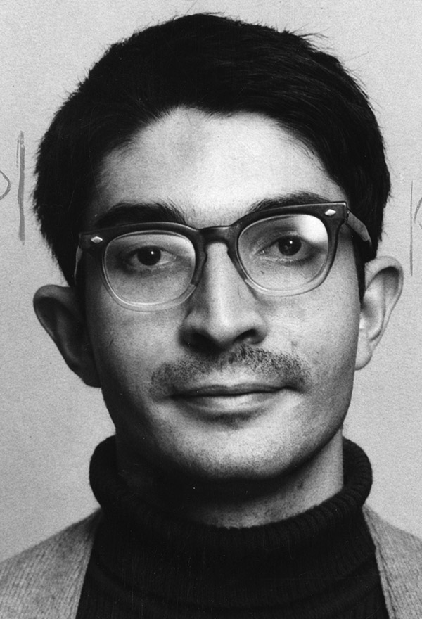 Photo of a young man with dark hair and glasses